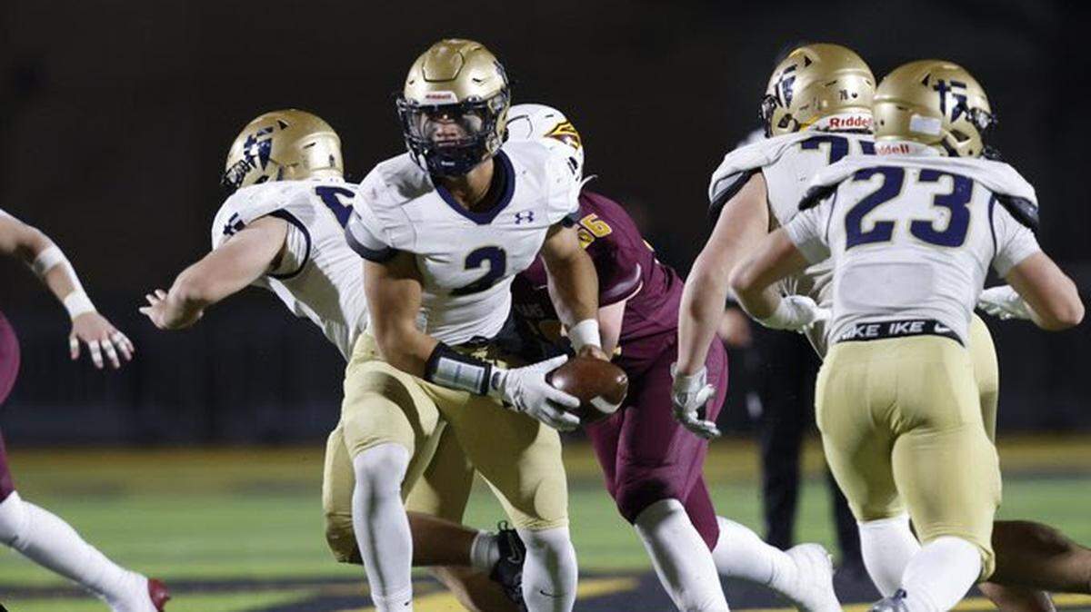 St. Thomas Aquinas senior quarterback Elzie Slaughter (No. 2) runs the offense during the Saints’ Kansas Class 5A high school football state championship game against Hays in Emporia, Kansas on Saturday, Nov. 30, 2024.