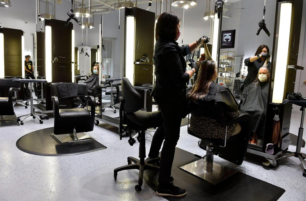 Rhonda Cavner, owner of Roca Salon & Spa in Midtown, recently gave Mary Maxson of Parkville a cut and color consultation. Among the many changes Cavner has had to adapt to because of COVID-19: learning to cut clients’ hair while they’re wearing a face mask.