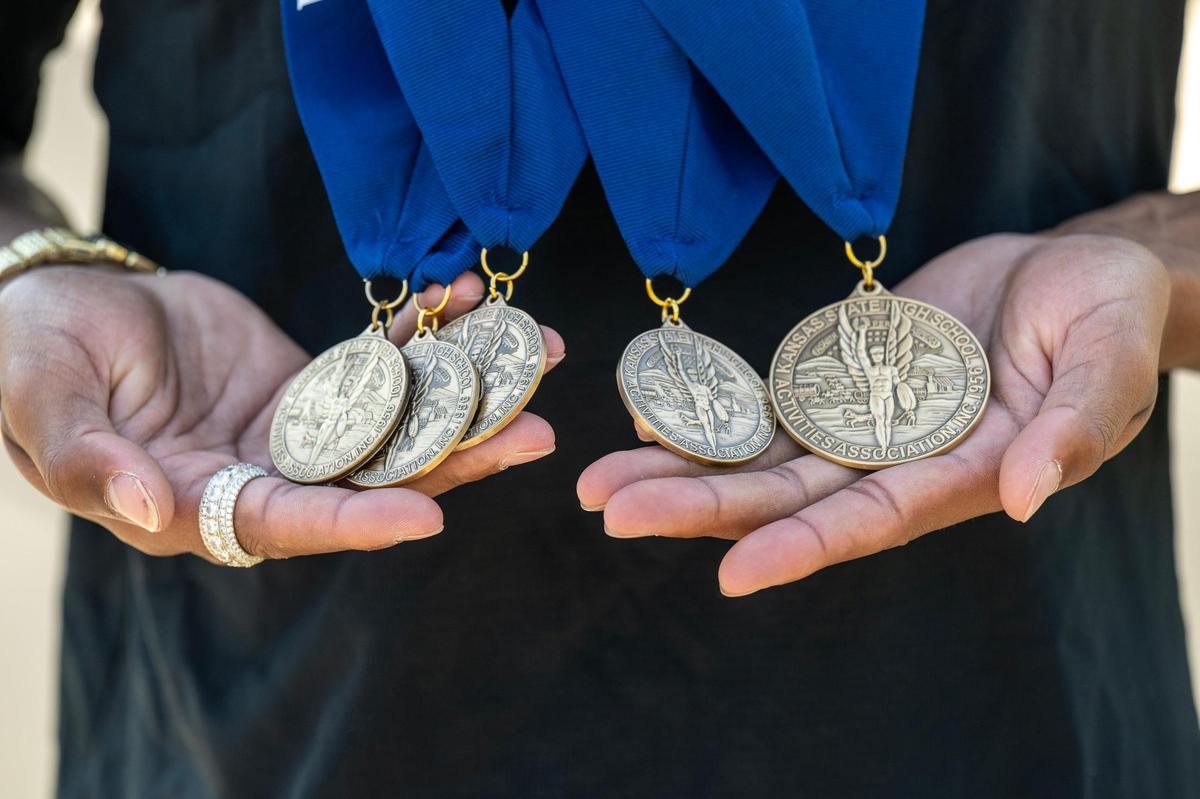 Jaalan Watson, 18, a graduate of Olathe North High School, displays some of the medals he won at Kansas State High School Activities Association’s track meets including the 6A state champion in the triple jump of 47-3.25.