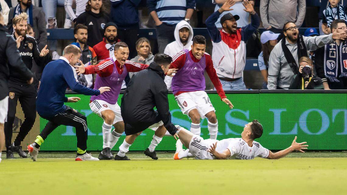 Real Salt Lake midfielder Damir Kreilach celebrates with teammates after scoring the winning goal in stoppage time during the second half of an MLS soccer match against Sporting Kansas City Sunday, Nov. 7, 2021, in Kansas City, Kan. (AP Photo/Nick Tre. Smith)
