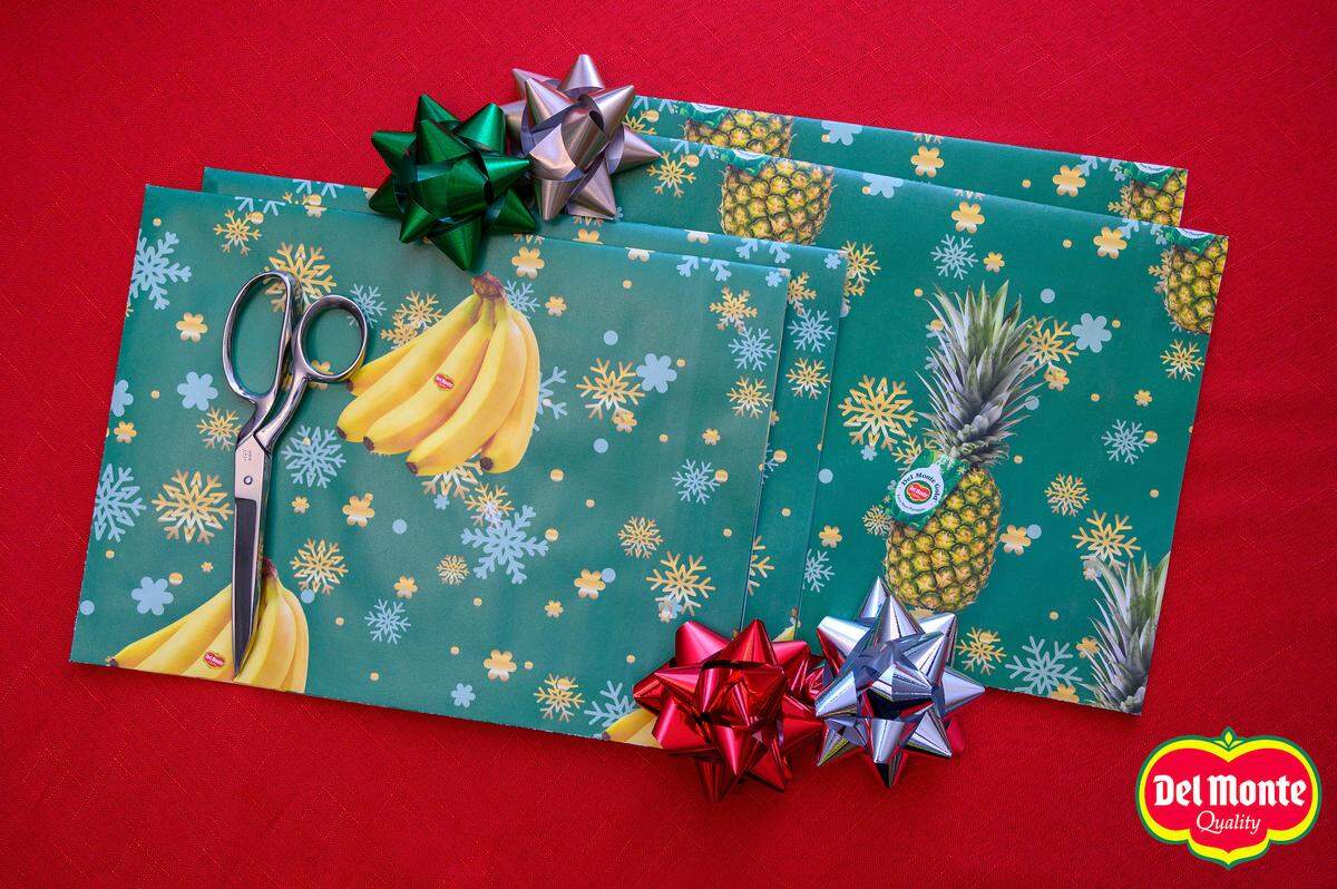 The wrapping paper is green and holiday-themed.
