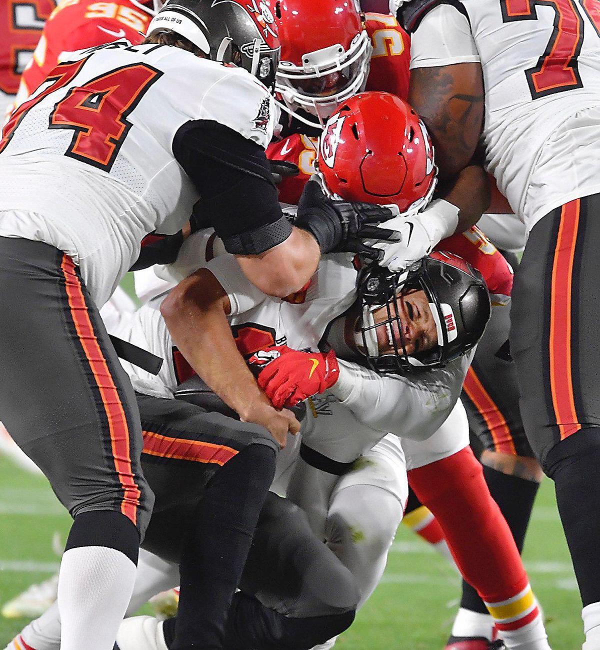 Tampa Bay Buccaneers quarterback Tom Brady is sacked by Kansas City Chiefs defensive end Frank Clark during the first quarter Sunday, February 7, 2021, at Super Bowl LV at Raymond James Stadium in Tampa, Florida.