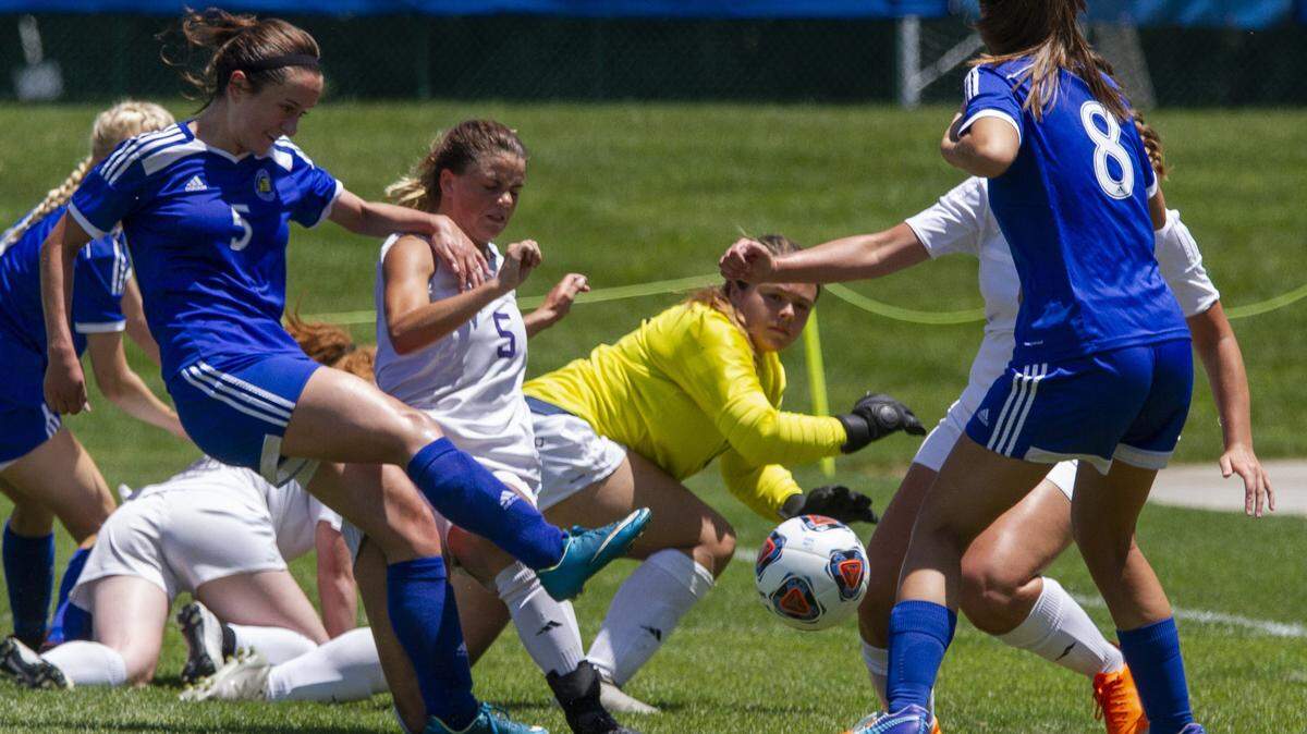 Rachel Kolich of St. Pius X takes a shot, but Pleasant Hill's Adelynn Link stands in the way to block it for Pleasant Hill on Thursday at Swope Park.