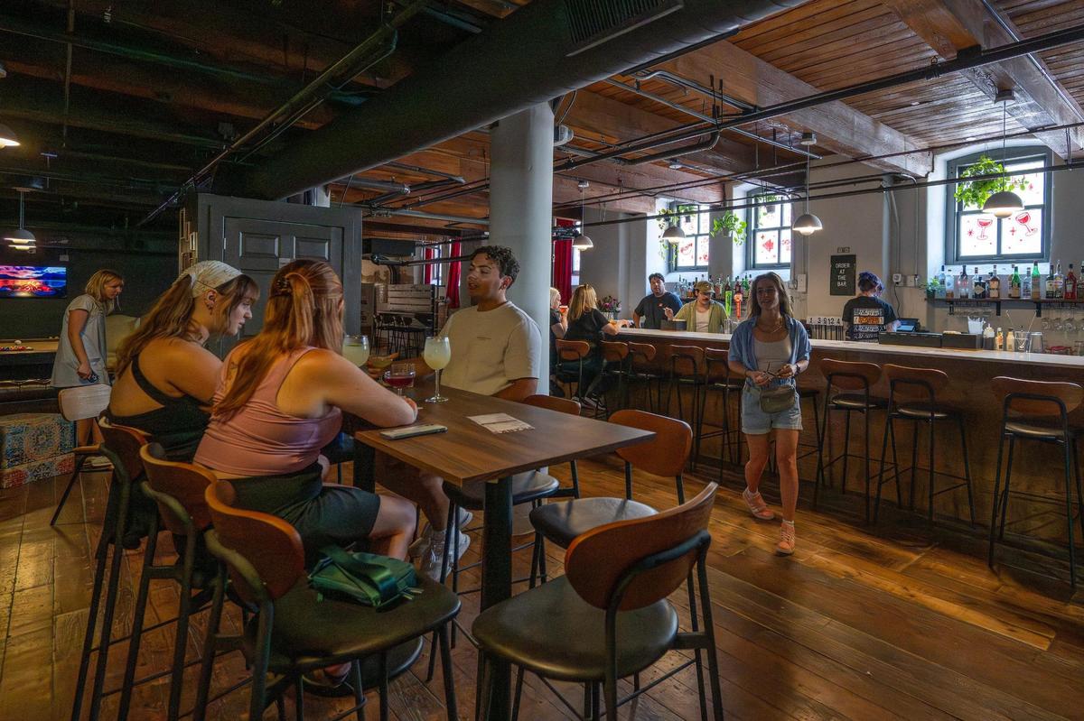 Guests sit at high tables near the bar at Something Good on Wednesday, July 16, in Kansas City.
