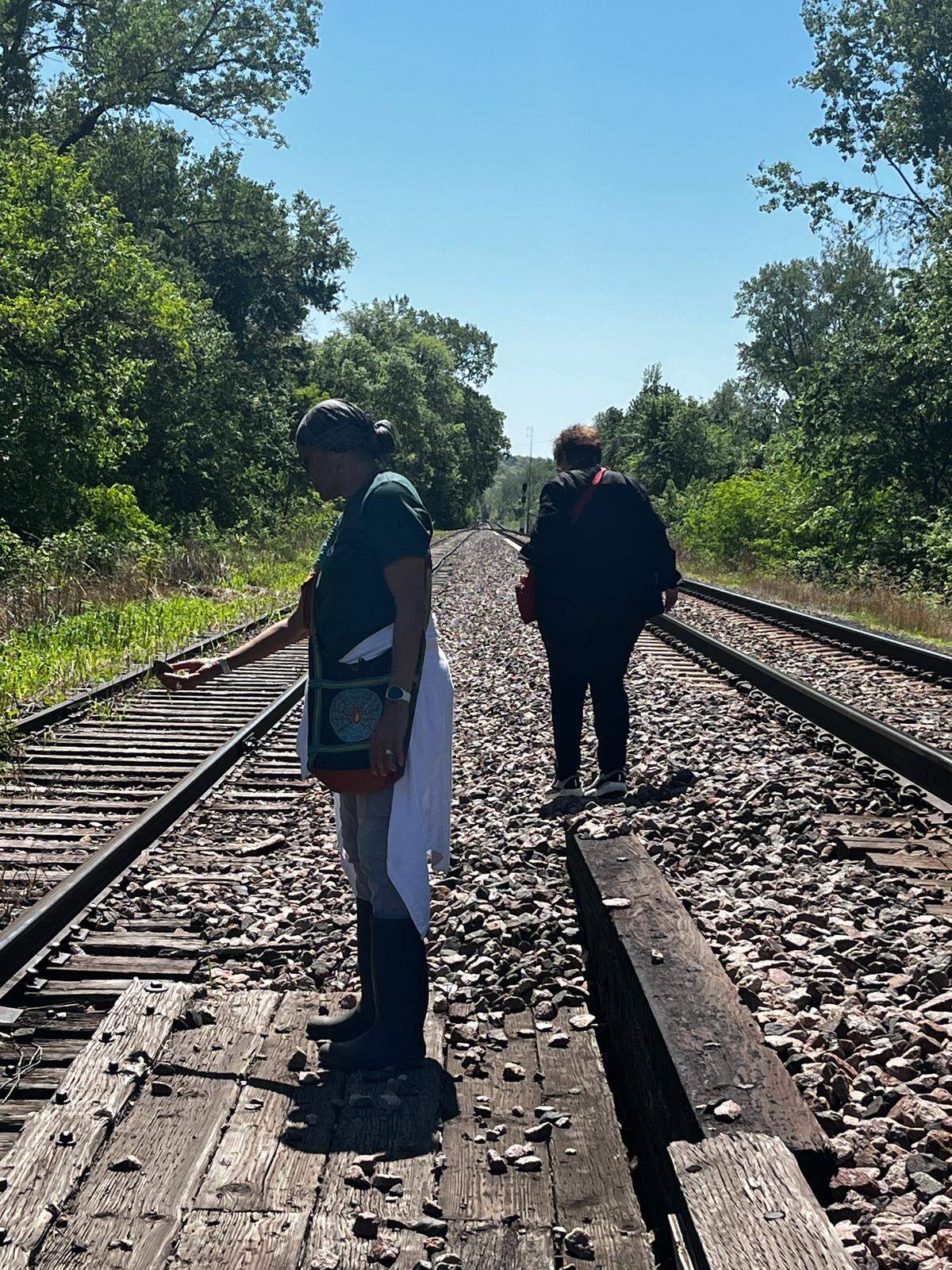 Members of the Community Remembrance Project in Weston walked along the railroad tracks looking for an old railroad bridge where a young Black man was lynched in 1881.