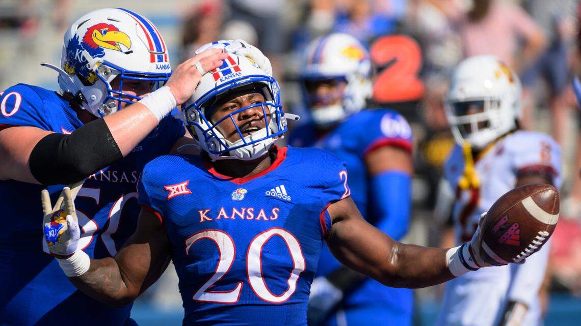 Kansas Jayhawks running back Daniel Hishaw Jr. (No. 20) celebrates with teammate Mike Novitsky (50) after scoring a touchdown against Iowa State on Saturday in Lawrence.