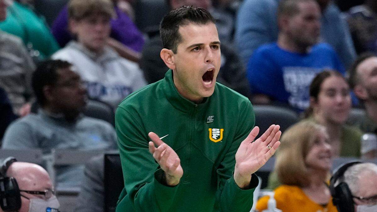 San Francisco head coach Todd Golden applauds his team during the first half of a college basketball game against Murray State in the first round of the NCAA tournament, Thursday, March 17, 2022, in Indianapolis. (AP Photo/Darron Cummings)