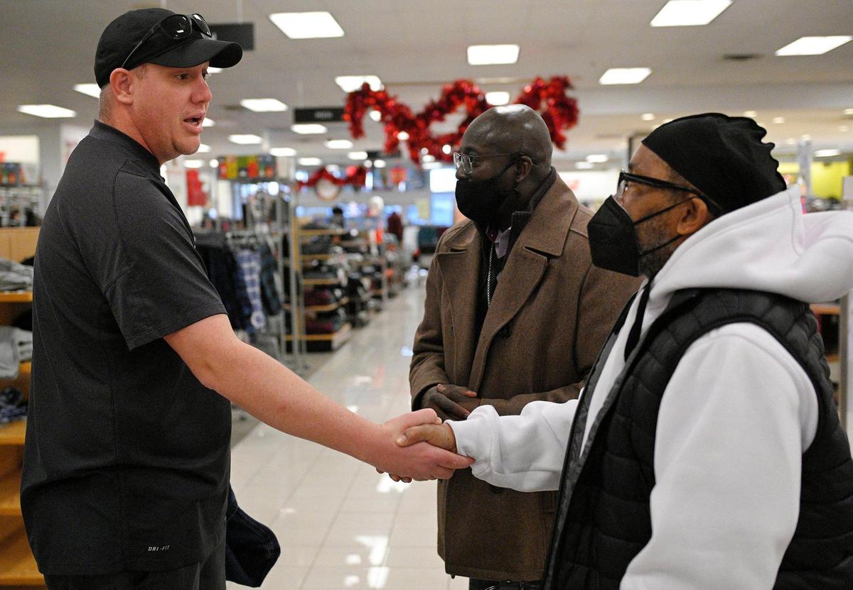 Markus Marrs of Blue Springs, left, approached Kevin Strickland, right, who was shopping for winter clothes with Darryl Burton on Tuesday, Dec. 21, 2021. Marrs shook Strickland’s hand and told him that he’d been following his story and wanted to wish him well.