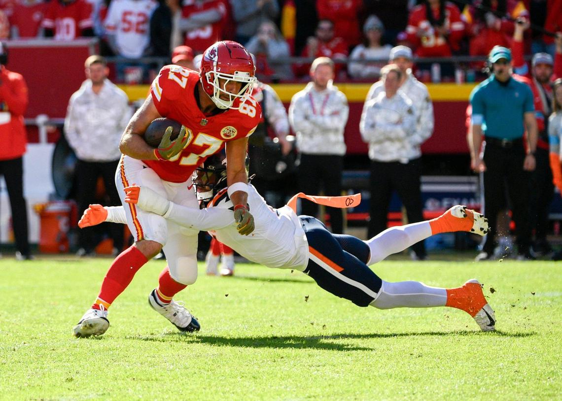 Kansas City Chiefs tight end Travis Kelce (87) gets tackled by the Denver Broncos in the first half on Sunday, Nov. 10, 2024, at GEHA Field at Arrowhead Stadium.