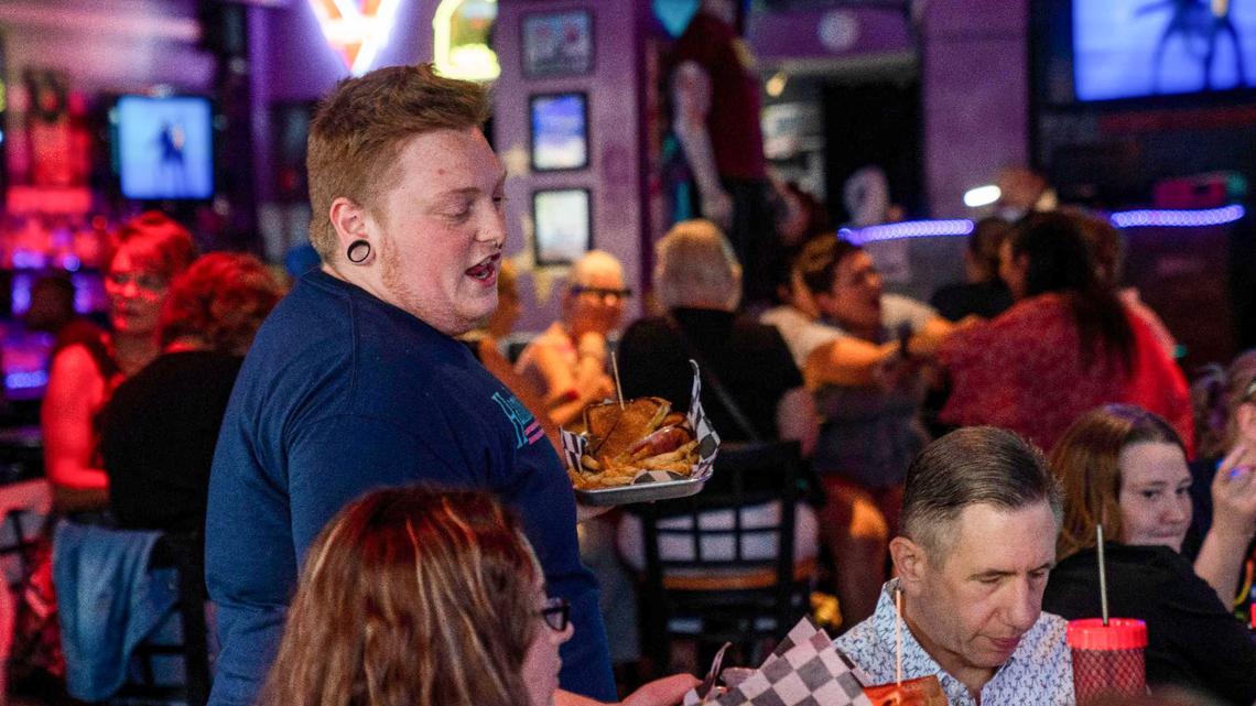 Silas Gardner serves food to customers,Thursday, June 24, 2021 at Hamburger Mary’s in Kansas City. Hamburger Mary’s and Woody’s KC, two LGBTQ bars along Broadway Boulevard in Kansas City’s Midtown, will require COVID-19 vaccination for customers soon.