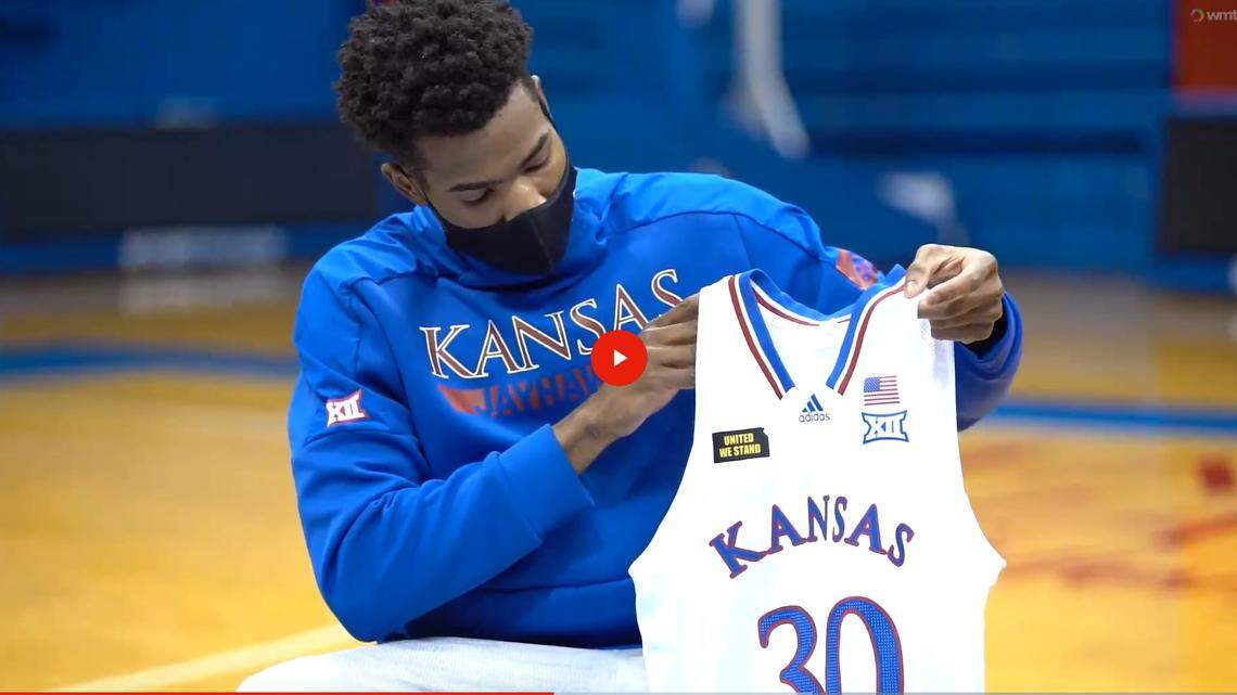 KU junior guard Ochai Agbaji shows off the “United We Stand” jersey patch he and teammate David McCormack created in a video produced by Kansas Athletics.