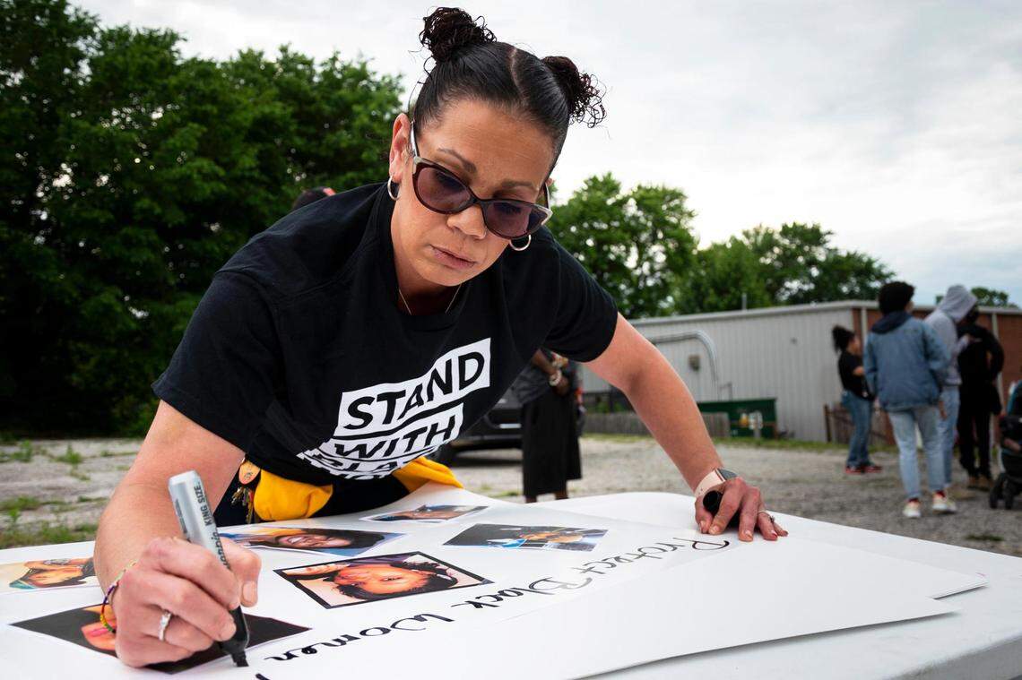 Dawn Oliver finishes a sign dedicated to Black women lost to police violence as people gather Wednesday evening, June 1, 2022, to protest the Kansas City police shooting of Leonna M. Hale, 26, of Kansas City, Kansas. Hale was shot as she fled an arrest Friday, May 27, 2022, at the Family Dollar, 634 Prospect Ave. After review of body cam footage, Hale was charged with unlawful firearm possession, exhibiting a firearm and resisting arrest, Prosecutor Jean Peters Baker’s office said on Wednesday, June 1, 2022.