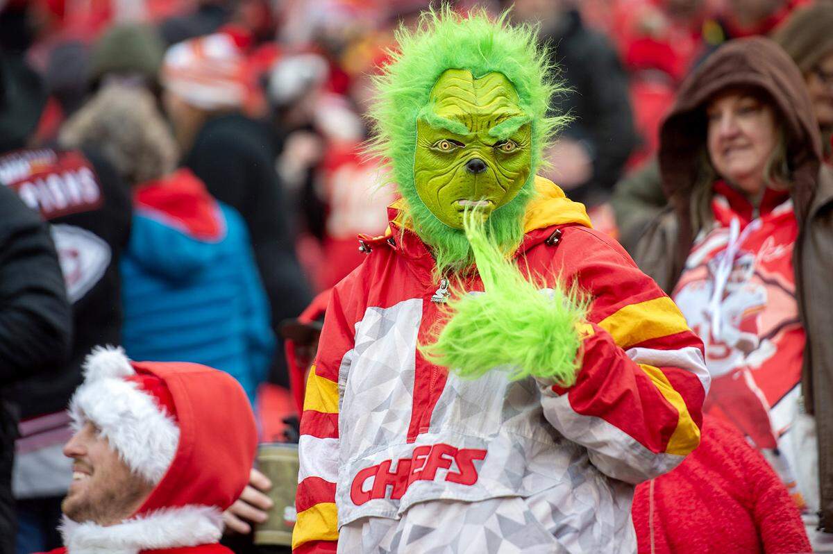 A Kansas City Chiefs fan dressed as Dr. Seuss’s “The Grinch” gives a thumbs up during an NFL football game against the Los Vegas Raiders at GEHA Field at Arrowhead Stadium during on Monday, Dec. 25, 2023, in Kansas City.
