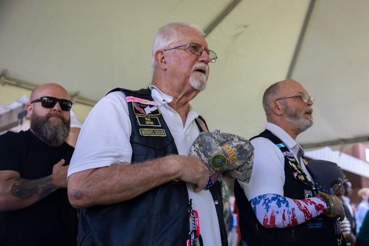 Members of the American Legion ____ hold their hats over their heart during the National Antihuman at St. Michael's Veterans Center on Monday, June 29, 2026. Valor House, the final residential building in St. Michael's Veterans Center's original campus master plan, adds 62 affordable apartment homes, expanding the campus to 179 permanent housing units for veterans experiencing homelessness or disabilities in the Kansas City area.