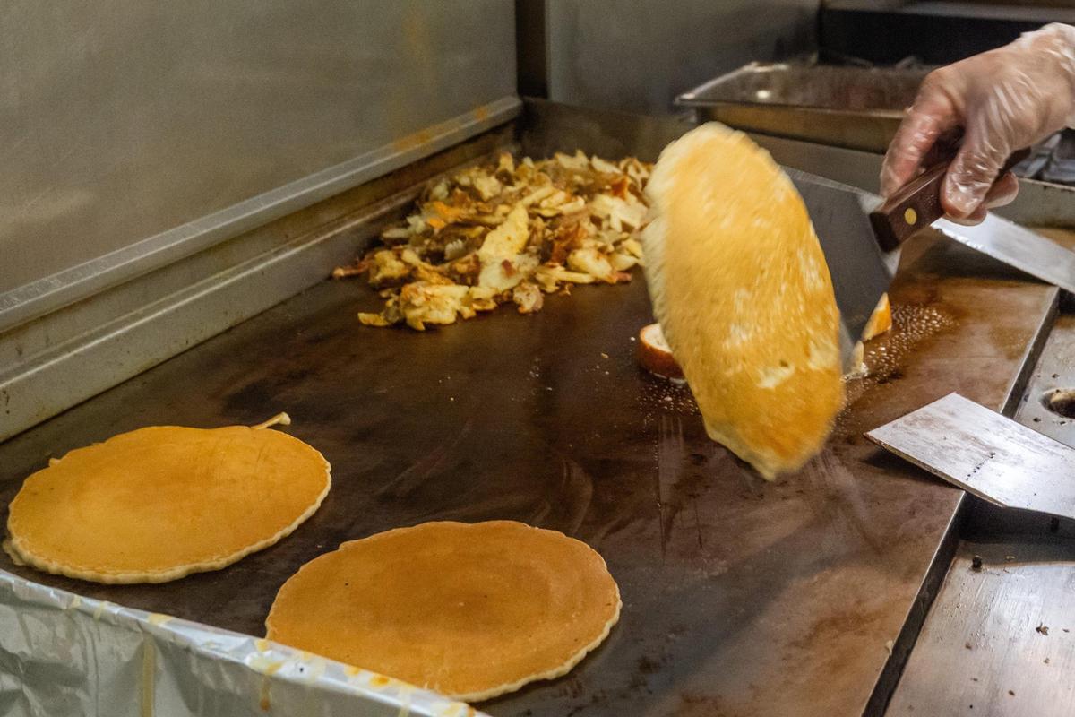 An order of Succotash’s signature pancakes are flipped in the kitchen on June 16. The cakelike flapjacks are great for splitting, The Star's Ilana Arougheti suggests.