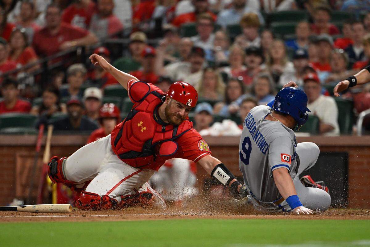Kansas City Royals first baseman Vinnie Pasquantino slides safely into home plate ahead of Pedro Pagés tag during the sixth inning of a series-opening game at Busch Stadium in St. Louis on Friday, May 15, 2026. The Cardinals beat the Royals 5-4 in 11 innings.