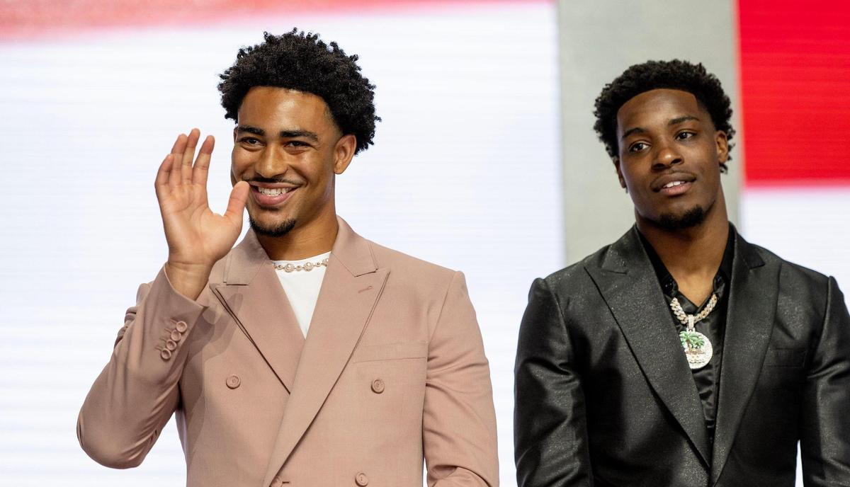 Alabama quarterback Bryce Young, left, waves to friends and family as he’s introduced during the NFL Draft outside of Union Station on Thursday, April 27, 2023, in Kansas City.
