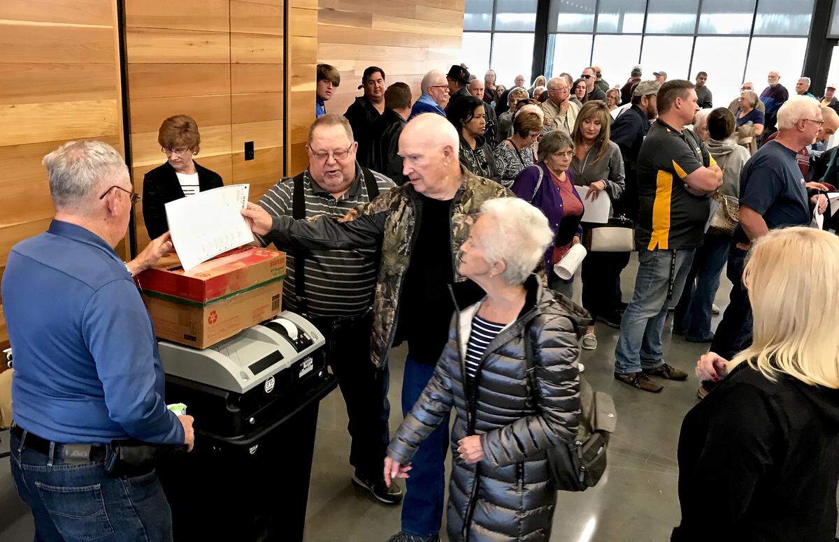 A ballot-counting machine at a polling location inside the Centerview building near Raymore City Hall malfunctioned Tuesday, temporarily forcing voters to place their ballots in a cardboard box.