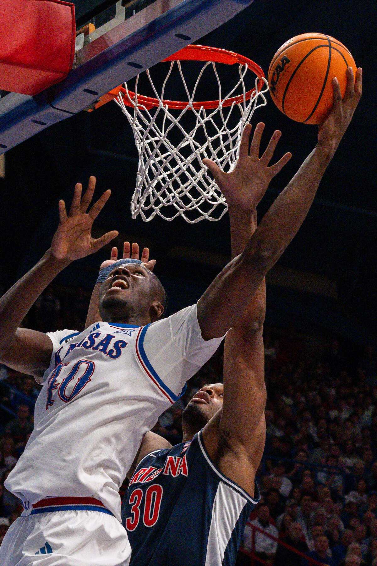 Kansas Jayhawks forward Flory Bidunga (40) shoots a layup over Arizona Wildcats forward Tobe Awaka (30) in the first half on Monday, February 9, 2026, at Allen Fieldhouse.