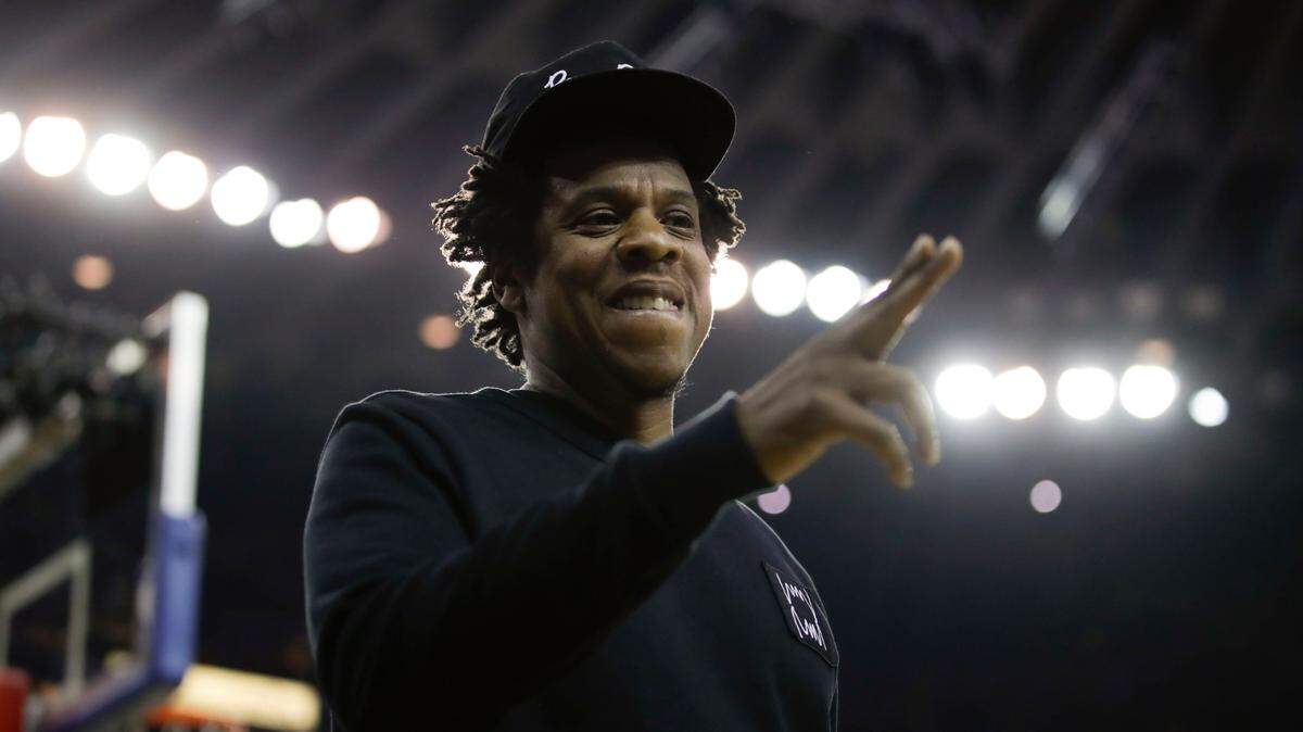 Jay-Z gestures while walking to his seat during the first half of Game 3 of basketball’s NBA Finals between the Golden State Warriors and the Toronto Raptors in Oakland, Calif., Wednesday, June 5, 2019. (AP Photo/Ben Margot)