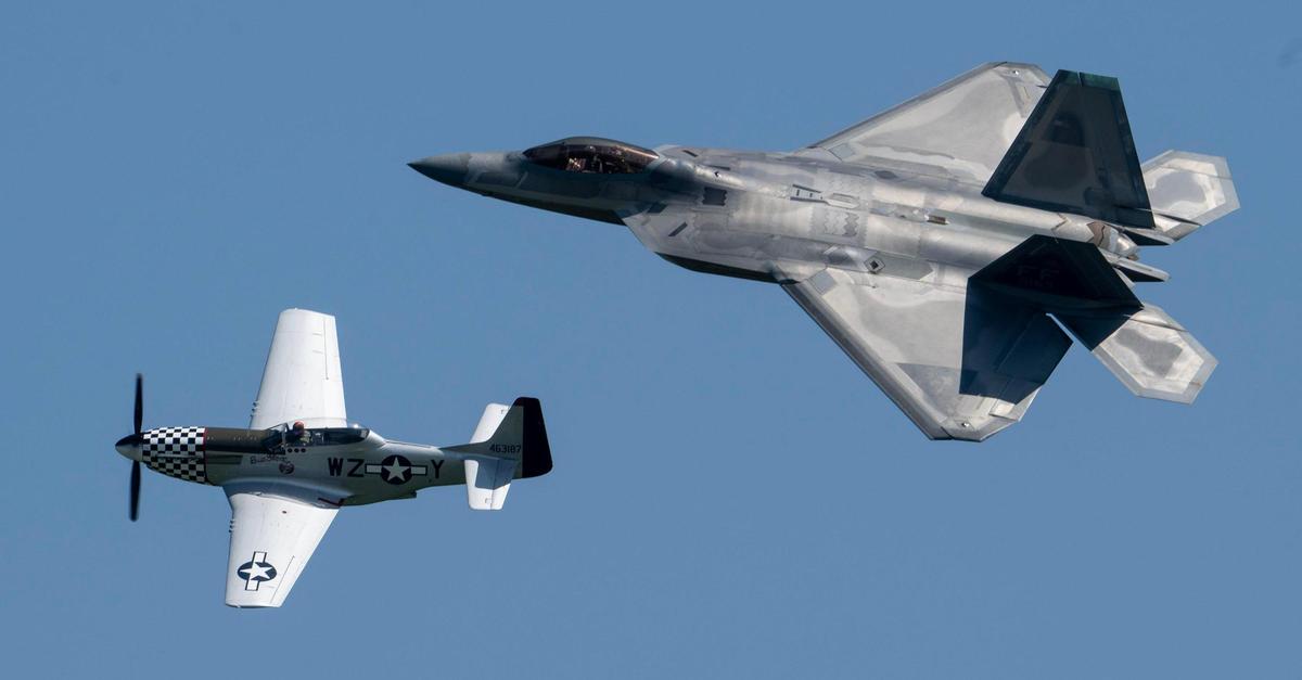 An Air Force F-22 Raptor fighter jet flies alongside a P-51 Mustang during the Garmin KC Air Show on Saturday, Aug. 19, 2023, in New Century.