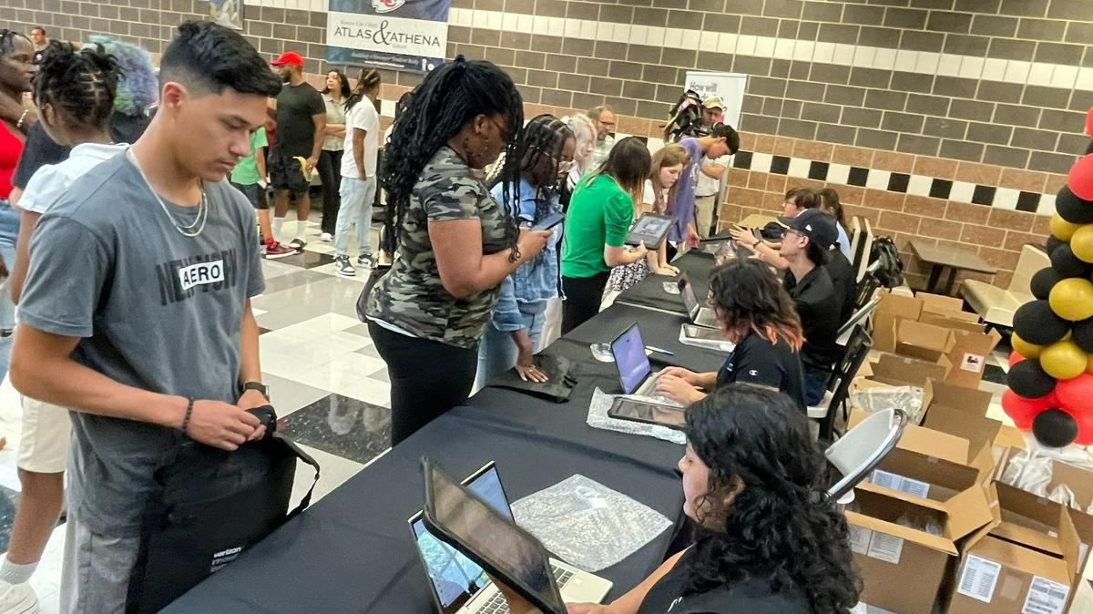 Crowds of parents and students filled the cafeteria at Paseo Academy of Fine and Performing Arts to receive their iPads for the school year.