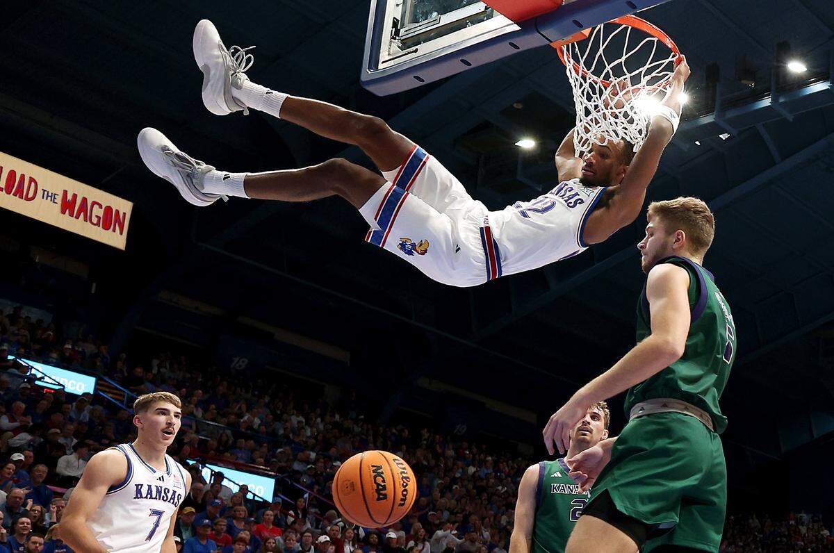 Guard Darryn Peterson #22 of the Kansas Jayhawks dunks on a fast break during the first half of the game against the Green Bay Phoenix at Allen Fieldhouse on November 3, 2025 in Lawrence.