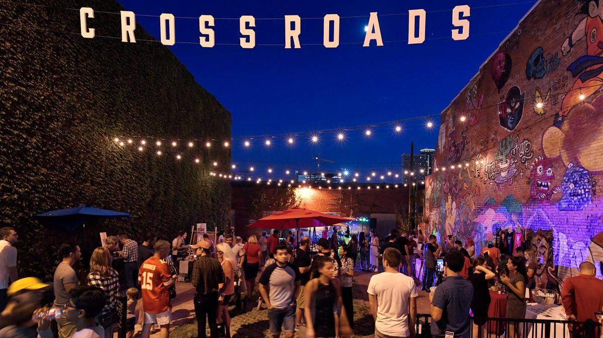 As live music filled the air in this nook in the east Crossroads, First Friday goers mingled along 18th Street.