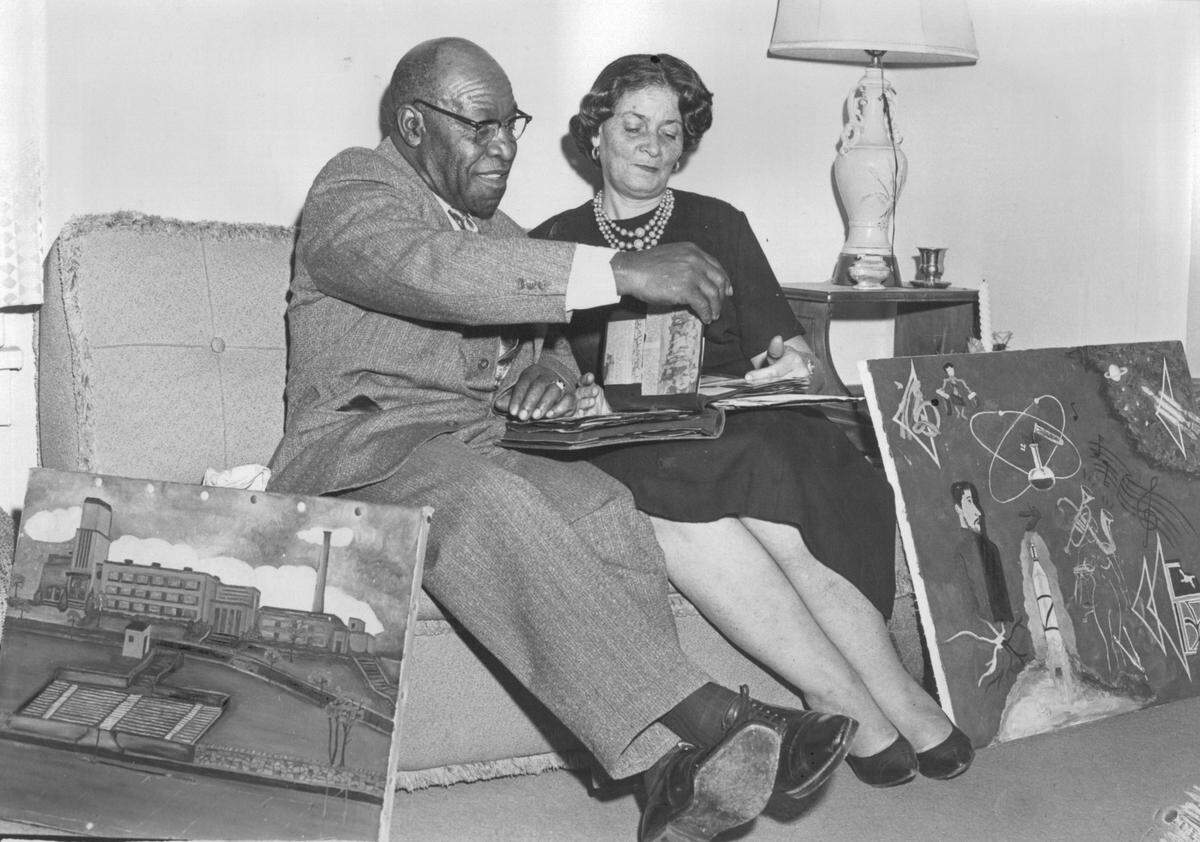 In 1963, Edward and Georgia Dwight, who met in Iowa when he was playing for the Kansas City Monarchs, look through a scrapbook of their son Capt. Edward J. Dwight Jr.’s accomplishments. Some of Dwight’s early paintings were on display, too.