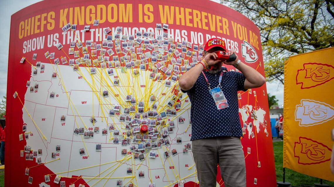 A Kansas City Chiefs employee takes a Polaroid photo of fans at the Chiefs Kingdom Experience exhibit during the NFL Draft on Thursday, April 27, 2023, in Kansas City. Chiefs fans were given the opportunity to place the photos on a map depicting where they traveled from around the world.
