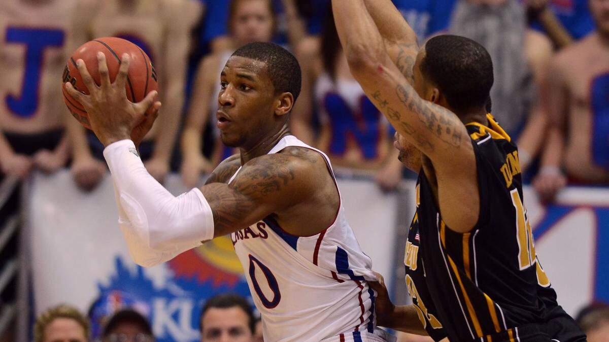 Missouri Tigers guard Marcus Denmon (12) defends Kansas Jayhawks forward Thomas Robinson (0) in the second half at Allen Fieldhouse on Feb. 25, 2012.