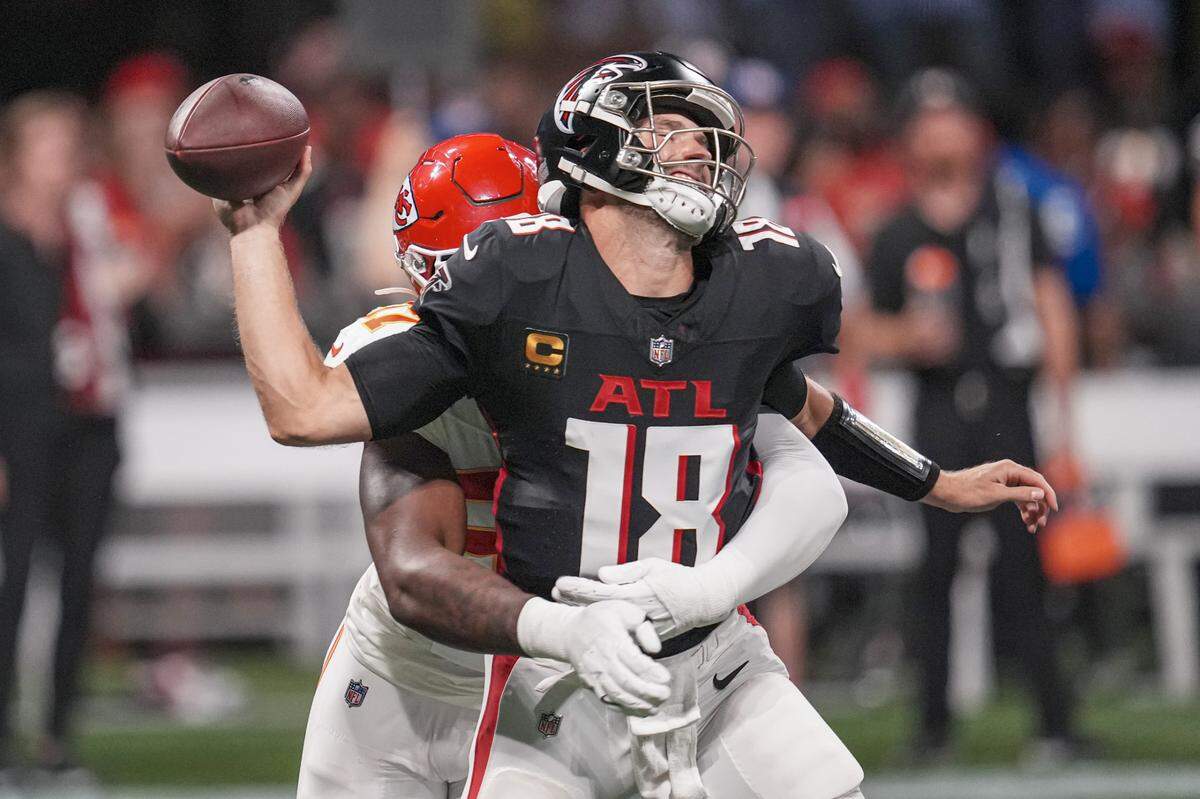 Atlanta Falcons quarterback Kirk Cousins is hit by Kansas City Chiefs defensive end Felix Anudike-Uzomah, losing the ball in the process during Sunday night’s game at Mercedes-Benz Stadium.
