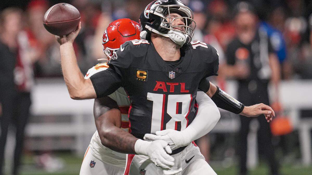 Atlanta Falcons quarterback Kirk Cousins is hit by Kansas City Chiefs defensive end Felix Anudike-Uzomah, losing the ball in the process during Sunday night’s game at Mercedes-Benz Stadium.