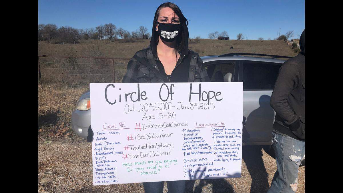 Maggie Drew attended a rally in November in Stockton, Missouri, to call attention to alleged abuses at Circle of Hope Girls Ranch and other faith-based reform schools. Her sign listed her own experiences, she said.