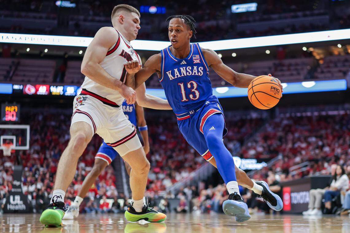 LOUISVILLE, KENTUCKY - OCTOBER 24: Elmarko Jackson #13 of the Kansas Jayhawks drives to the basket against Isaac McKneely #10 of the Louisville Cardinals during the second half of the NCAA exhibition game between the Louisville Cardinals and Kansas Jayhawks at KFC YUM! Center on October 24, 2025 in Louisville, Kentucky. (Photo by Michael Hickey/Getty Images)