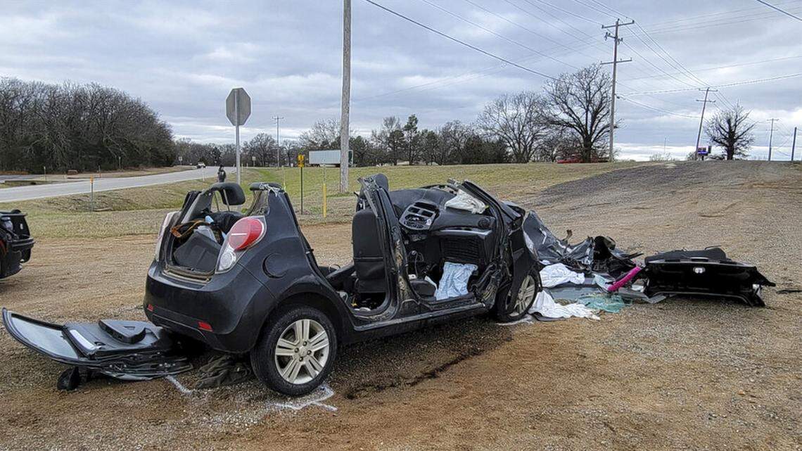 In this image provided by KFOR-TV, a heavily damaged vehicle is seen off a road in Tishomingo, Okla., following a two-vehicle collision in which six teenage students were killed, Tuesday, March 22, 2022.