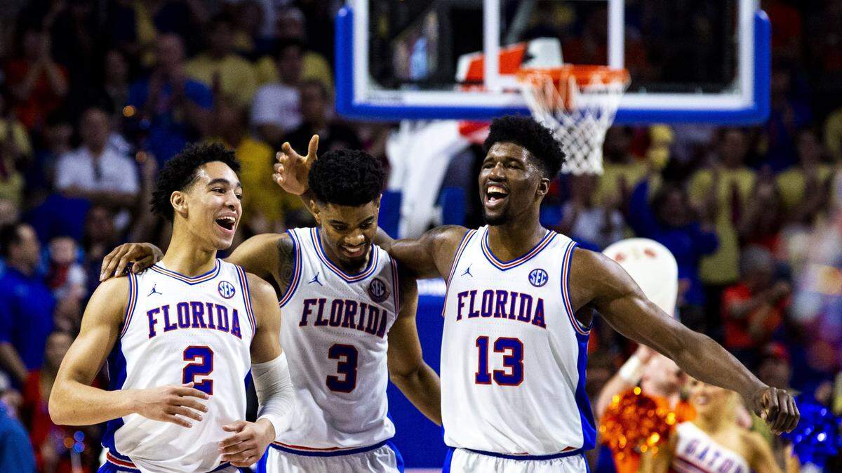 Florida’s Andrew Nembhard (2), Jalen Hudson (3) and Kevarrius Hayes (13) celebrate during during an NCAA college basketball game against Missouri, Saturday, Feb. 23, 2019. (Lauren Bacho/The Gainesville Sun via AP)