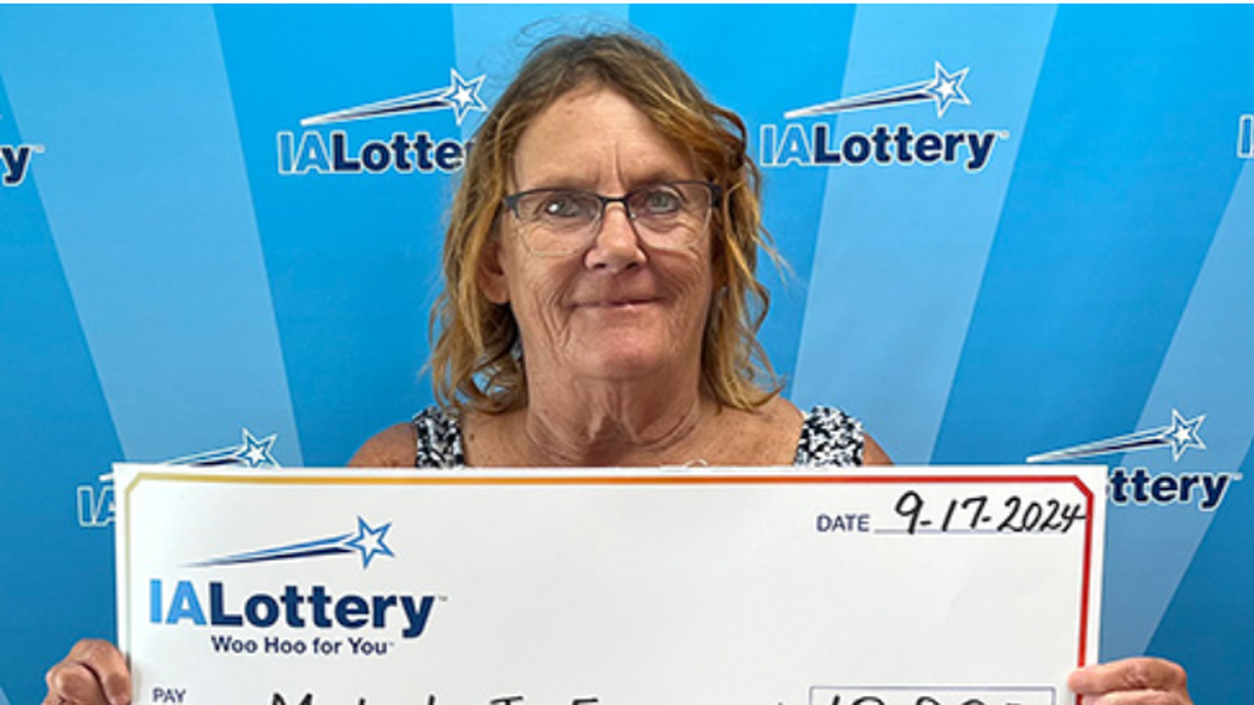 An Iowa woman won big in the lottery by playing the same game that her best friend had luck in, officials said.
