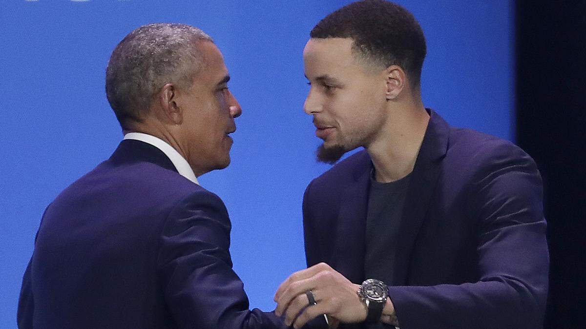 Former President Barack Obama, left, hugs Golden State Warriors basketball player Stephen Curry after speaking at the My Brother’s Keeper Alliance Summit in Oakland, Calif., Tuesday, Feb. 19, 2019.