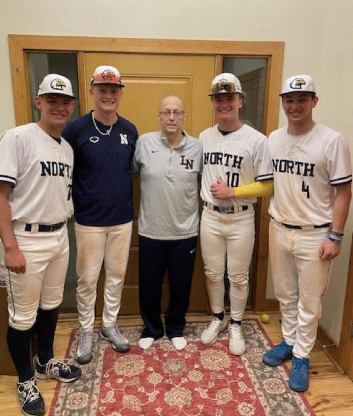 Liberty North baseball coach Rob James (middle) stands with four of his players’ Ty Wisdom (far left), Tate McGuire (middle left), Trey Snyder (middle right) and Jackson Downing (far right) after a game.