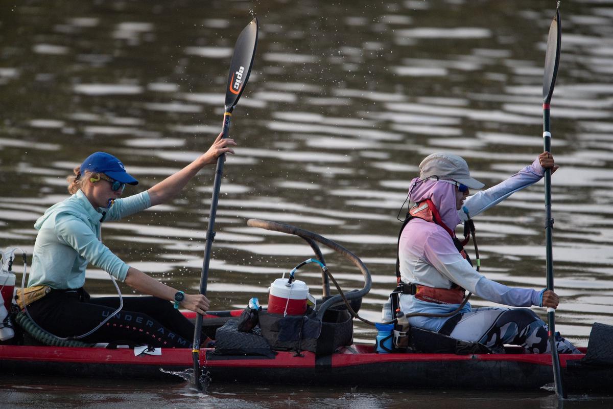A two person team competing in the MR340 river race warms up on the Missouri River before the start of the race.