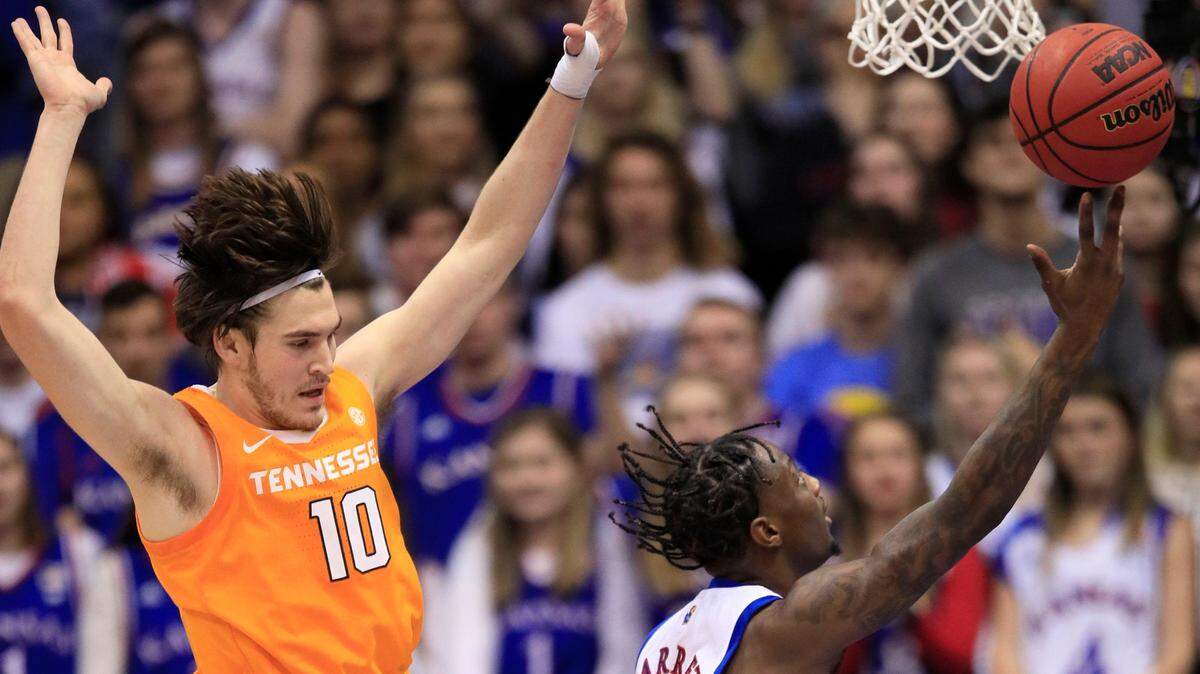 Tennessee forward John Fulkerson (10) and Kansas guard Marcus Garrett (0) during the second half of an NCAA college basketball game in Lawrence, Kan., Saturday, Jan. 25, 2020. Kansas defeated Tennessee 74-68. (AP Photo/Orlin Wagner)