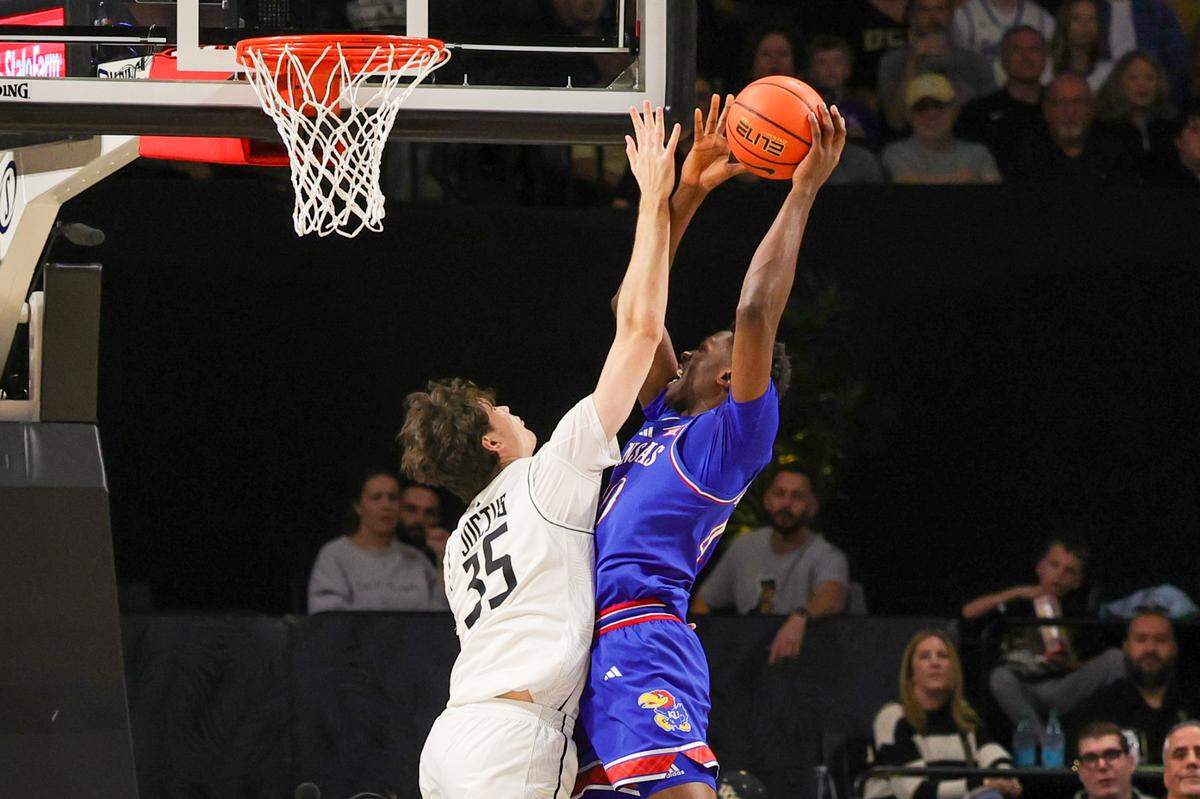 Kansas Jayhawks forward Flory Bidunga, right, puts up a shot against UCF Knights forward Rokas Jocius during a Sunday, Jan. 5, 2025 men’s college basketball game in Orlando.