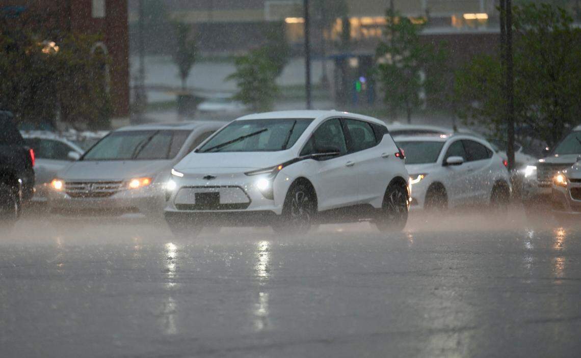 Cars drive through the rain on 95th Street near Oak Park Mall in Overland Park on Friday, April 17, as rain starts falling across the metro. Severe thunderstorms are expected.