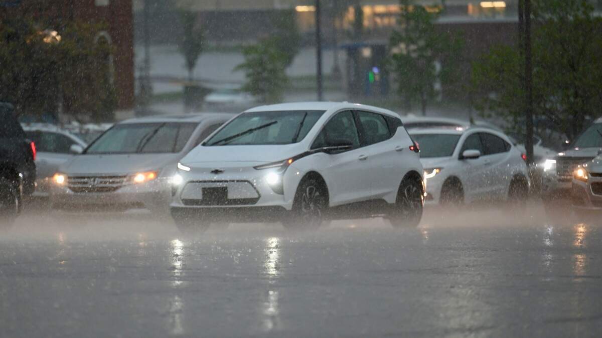 Cars drive through the rain on 95th Street near Oak Park Mall in Overland Park on Friday, April 17, as rain starts falling across the metro. Severe thunderstorms are expected.