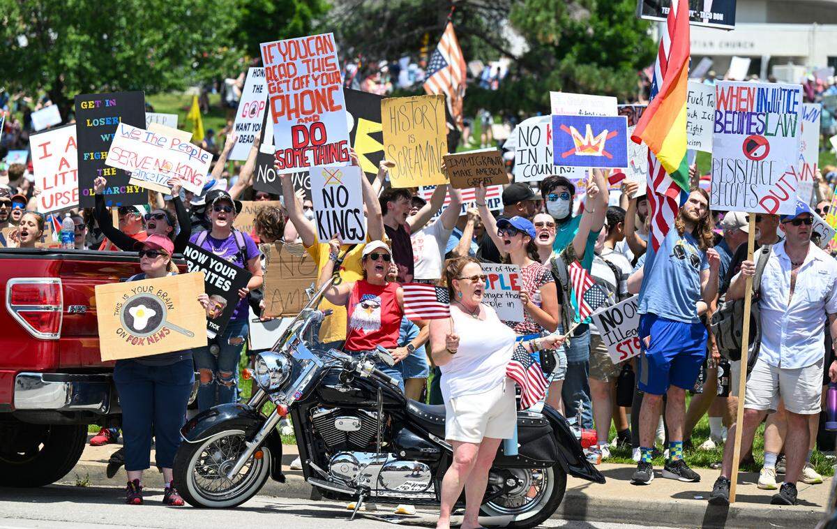 Protesters voice their dissent for the Trump administration during the “No Kings” rally Saturday, June 14, 2025, at Mill Creek Park in Kansas City.