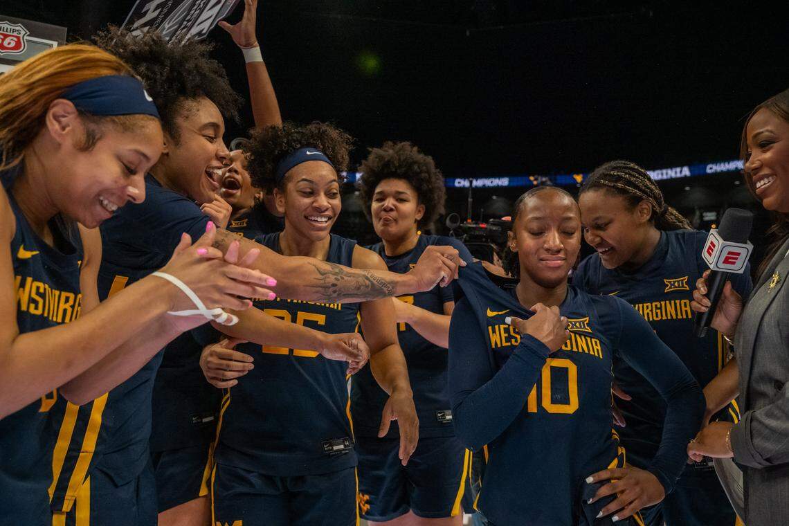 West Virginia Mountaineers guard Jordan Harrison (10) sheds a tear at half court as the West Virginia Mountaineers celebrate winning the Big 12 Women's Basketball Tournament Final on Sunday, March 8, 2026, at T-Mobile Center.