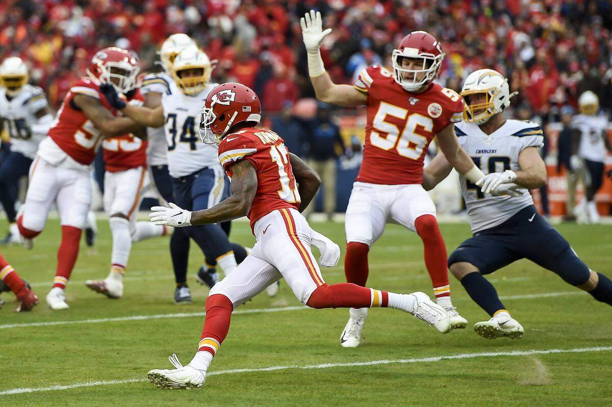 Kansas City Chiefs linebacker Ben Niemann (56) blocks Kansas City Chiefs wide receiver Mecole Hardman (17) runs a kickoff back for a 104-yard touchdown in the third quarter of the Kansas City-Los Angeles Chargers game Sunday, Dec. 29, 2019 at Arrowhead Stadium in Kansas City.