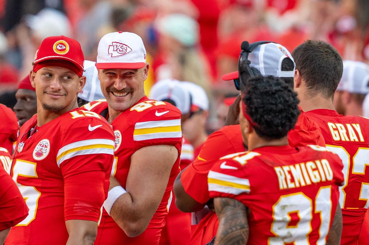 Kansas City Chiefs quarterback Patrick Mahomes (15) and tight end Travis Kelce (87) smile while standing on the sidelines in the fourth quarter during a game against the Detroit Lions on Saturday. (081724, Arrowhead Stadium)