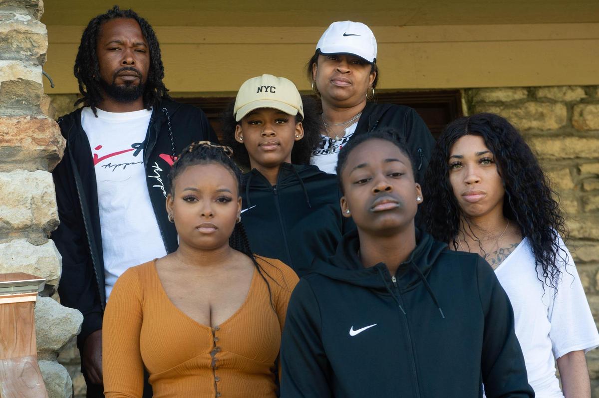 The family of 12-year-old Brian Henderson Jr., father, Brian Henderson, mother, Monica Henderson, sisters, from left to right, Kelsey Henderson, Brilyn Henderson, Brooke Johnson and Bobbi Hubbard, were pictured in front of their Kansas City home. Brian Henderson Jr., a student at University Academy, known as BJ to his family and friends, was fatally shot outside a pharmacy store in Leavenworth on April 14, 2021. “He was destined to be great,” said Brian Henderson of his son.